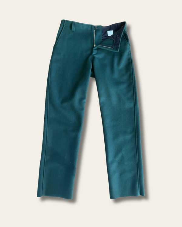 Solid green wool hunting pants on a beige background
